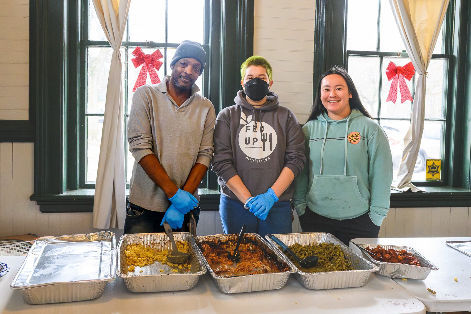 Todd Crowley, Kieren Berres, and Maddy Tong of FedUp Ministries serving food at the Ypsilanti Freighthouse daytime warming center.