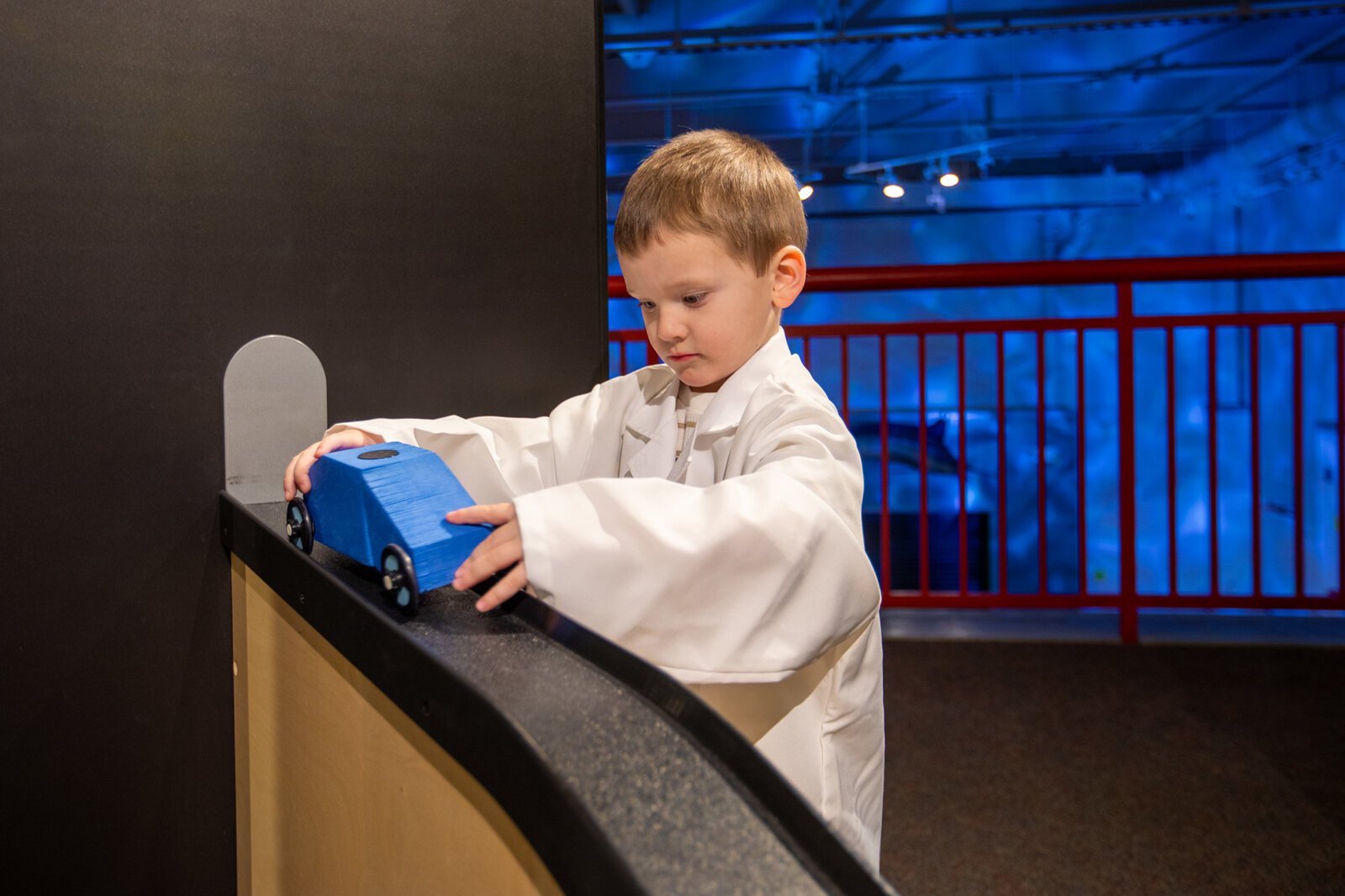 A child tests a toy car in the Mobilab exhibit at the Ann Arbor Hands-On Museum.