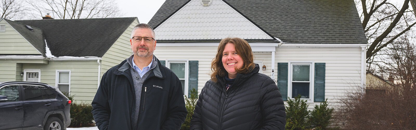 Luther Blackburn with Katelyn Zak in front of her home that had its lead service lines replaced by YCUA.