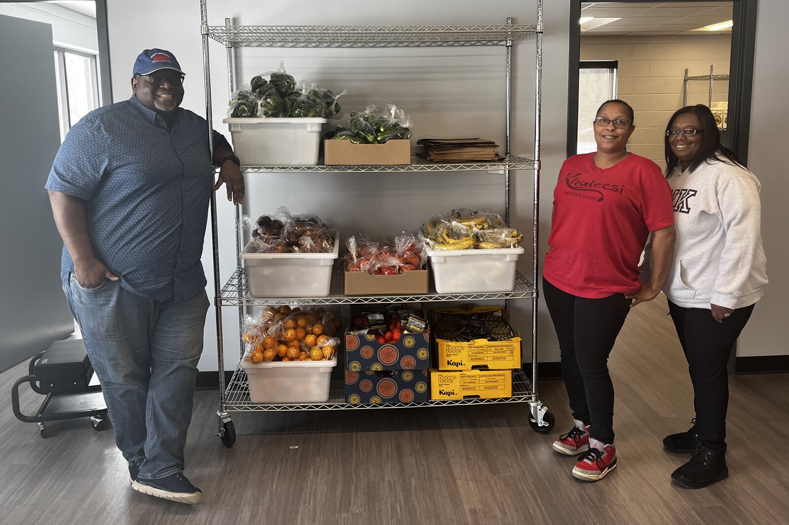 Bonnie Billups Jr., Lakesha Williams, and Latricia Juide in the HUB Community Center food pantry.