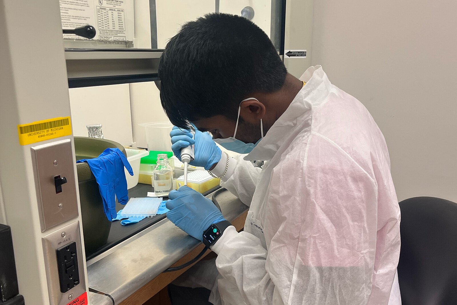 A University of Michigan Synthetic Biology Team member working in the lab.