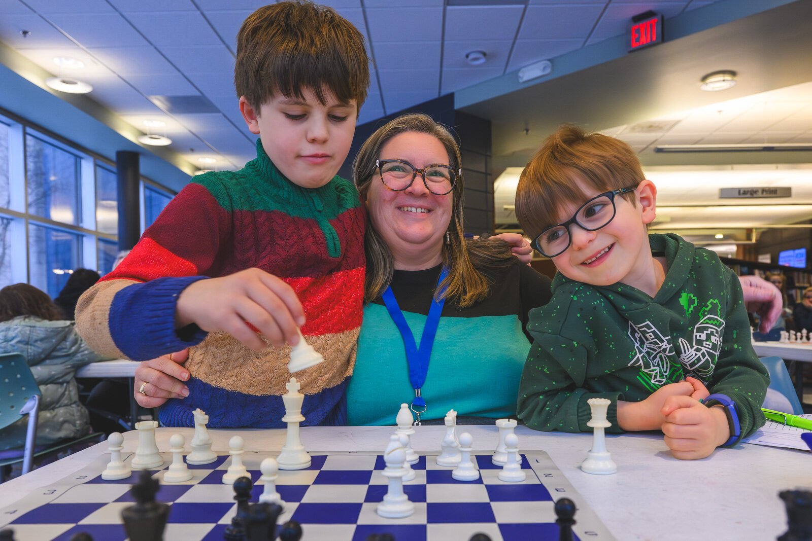 YDL Youth Chess Club mentor Jennifer Skidmore Smith and her sons.