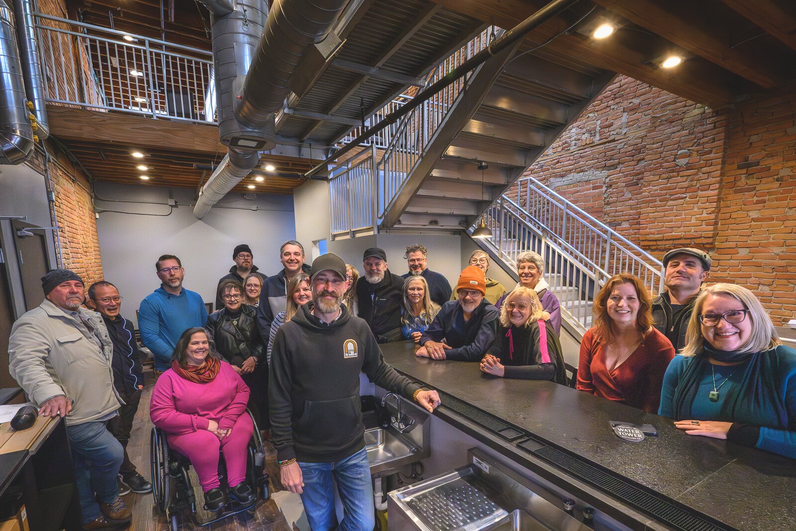 Skott Schoonover being visited by his Ypsilanti Sunday brunch group at Water Tower Distilling.