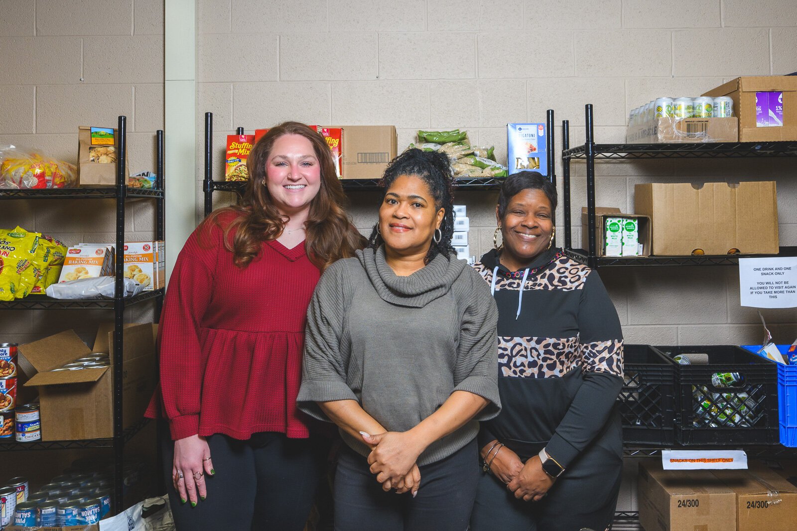 Assistant manager Lindsay Bohn, manager Tonysha Emerson, and assistant manager Sonya Rougeau at YCHS' food pantry.