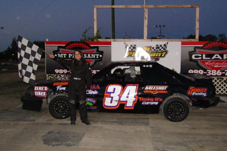 Maggie Dickman with her car at the Mt. Pleasant Speedway.