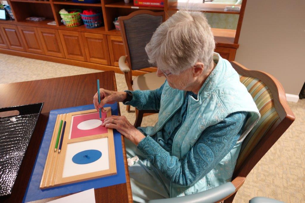 A resident participates in montessori activities