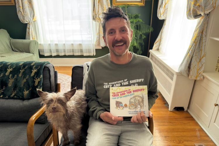 Local author Dominic Thrasher with his recently released children's book, The Adventures of CeCe and the Sheriff: Case of the Missing Bone.