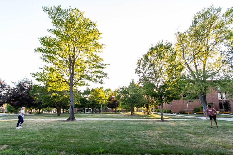 Izzy Slate, 21, of Allen Park and Johnny Palmer, 20, of Rochester play frisbee on Central Michigan University’s campus. 