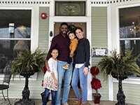 David and Layla Davis pose with their two children, Olivia and Liam, in front of the Gingko Tree Inn.