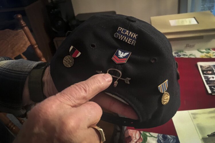 •	WWII veteran Henry Meabrod Sr. shows various medals he received from his service in the Navy.