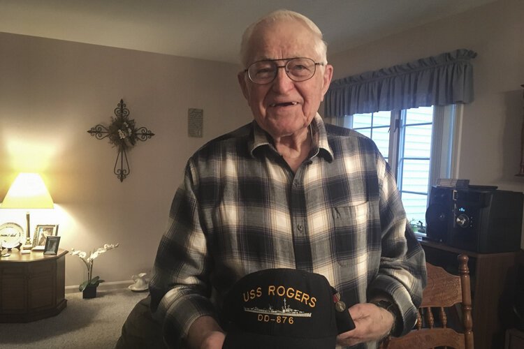 •	Henry Meabrod Sr. shows his WWII hat.