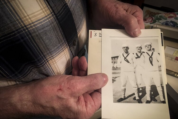 •	Henry Meabrod Sr. shows a photo of himself (middle) and two friends during his service in the Navy in WWII.