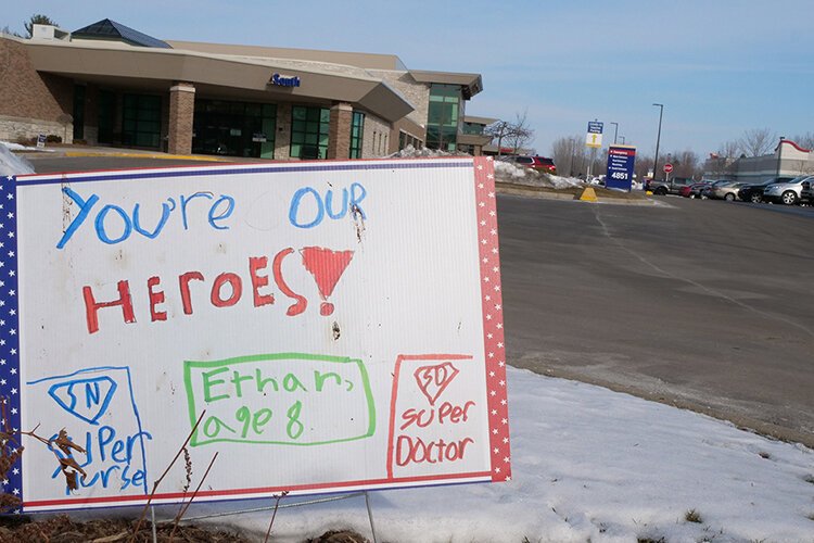 A sign decorates the lawn at MidMichigan Health, encouraging physicians and staff as they come into work each day. 