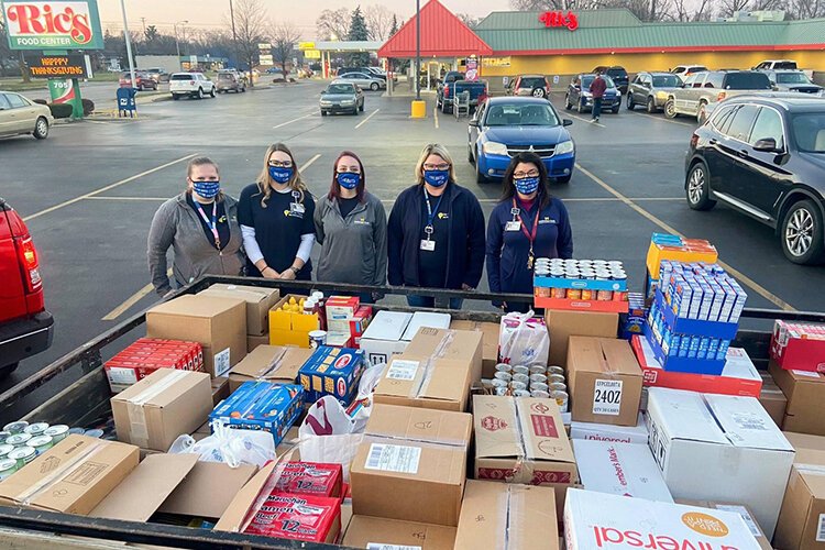 MidMichigan Health employees stand by donations collected for United Way’s Fill-A-Mayflower campaign.