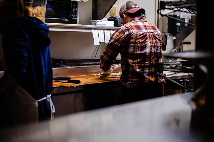 The Cabin employees work on completing orders Feb. 26.