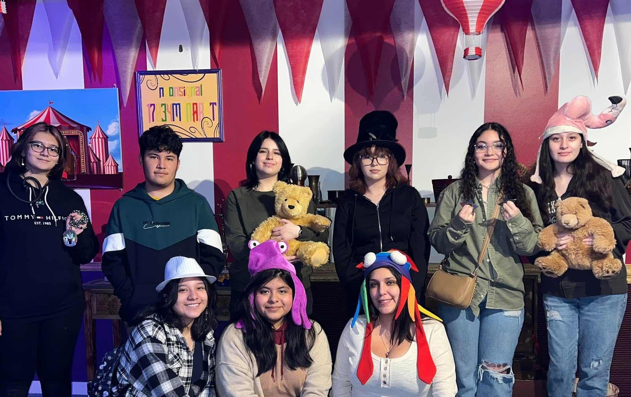 Participants in the CALM immigrant teen mental health program run by One Michigan pose at an escape room, chosen by the group for a fun activity to accompany a serious discussion