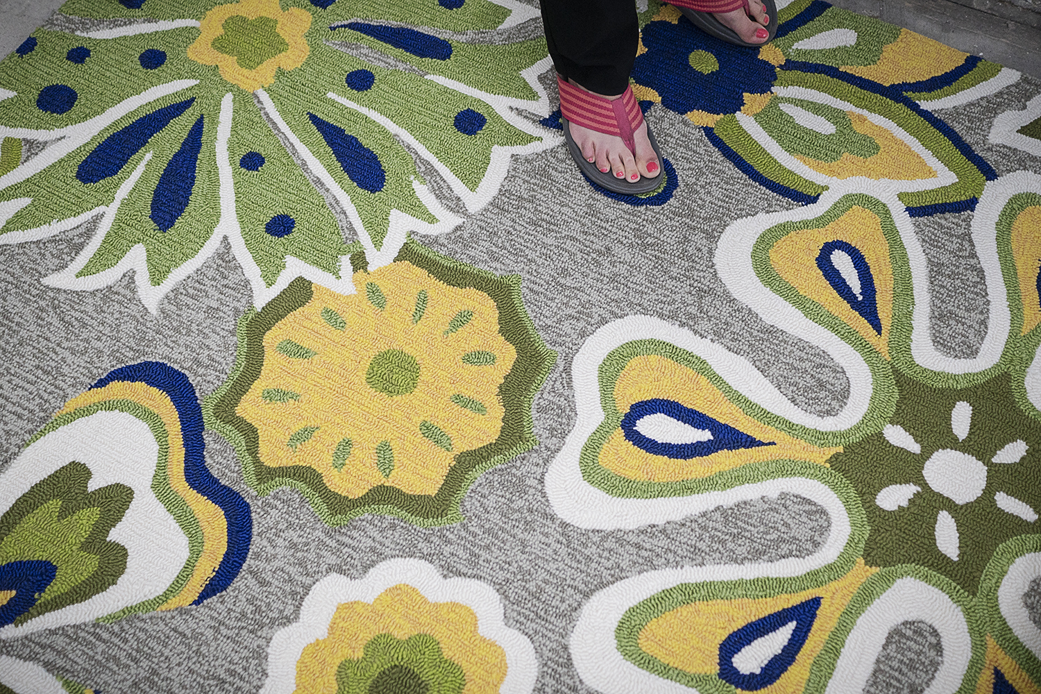 Flint, MI - Thursday, June 22, 2018: Choice Office Products sales representative Julie Cauley (47) from Flint positions an area rug in her new office at The Ferris Wheel in Downtown Flint.