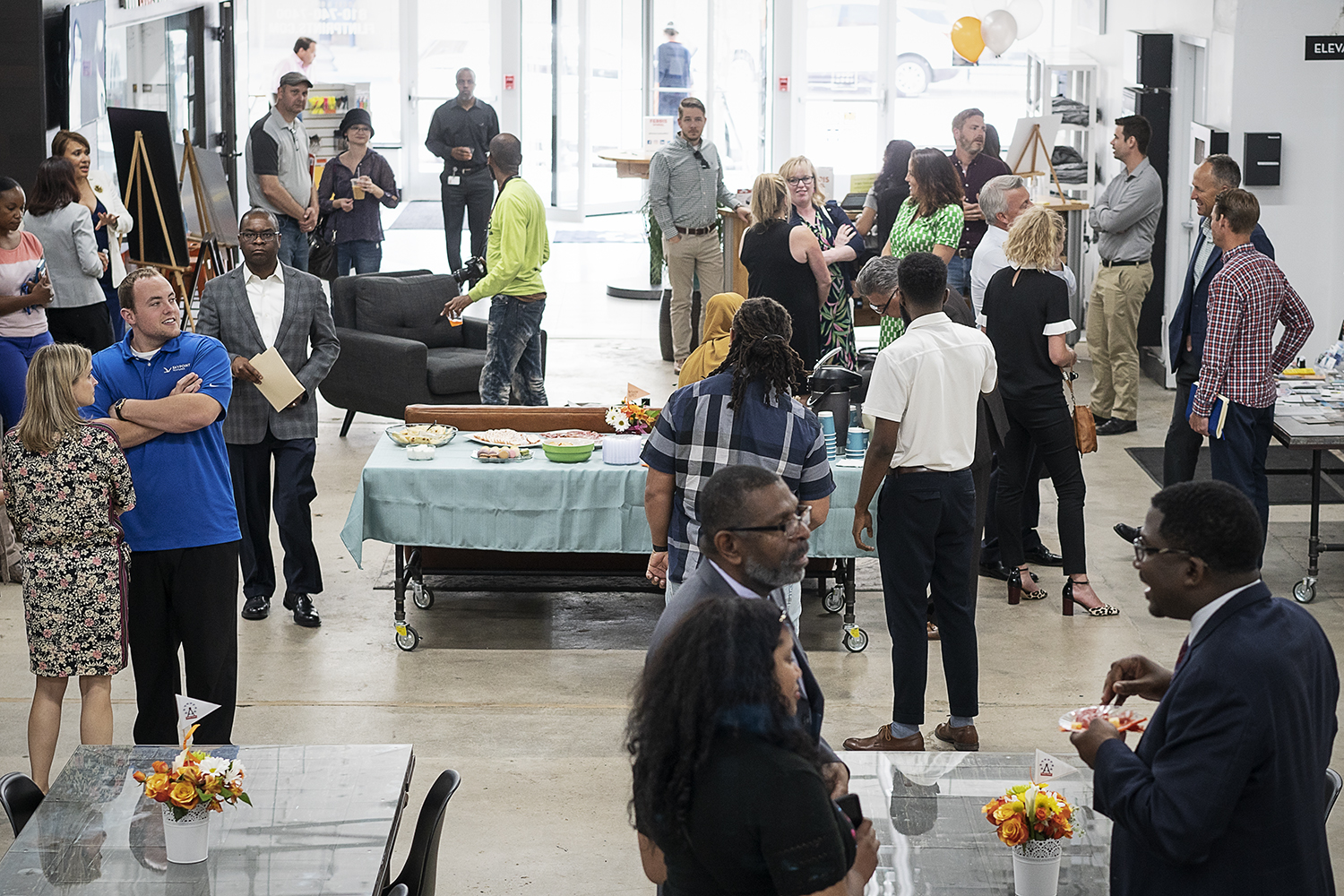 Flint, MI - Thursday, June 22, 2018: Attendees gather in the lobby at The Ferris Wheel in Downtown Flint for the move-in party.