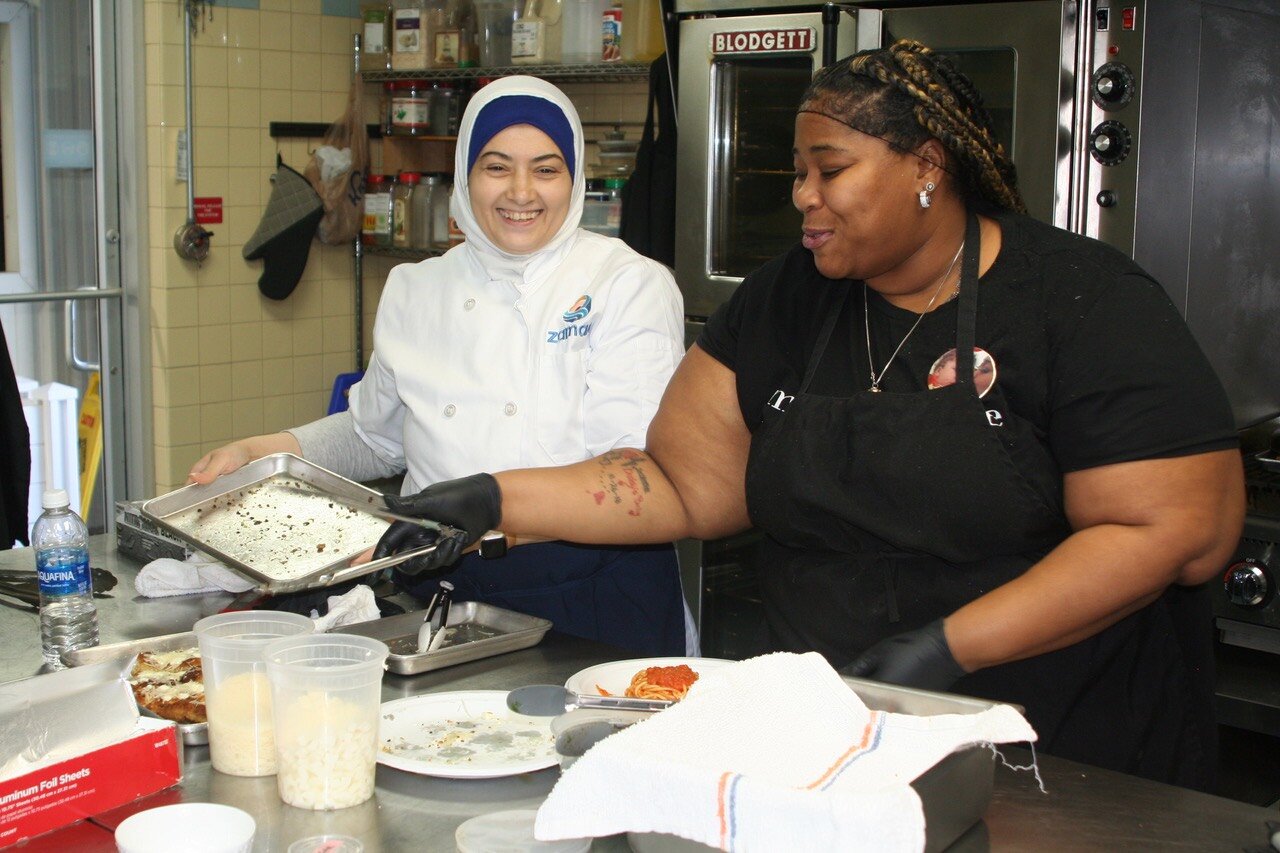 Israa Jawad and Charisse Copeland gain hands-on experience in Zaman's training kitchen