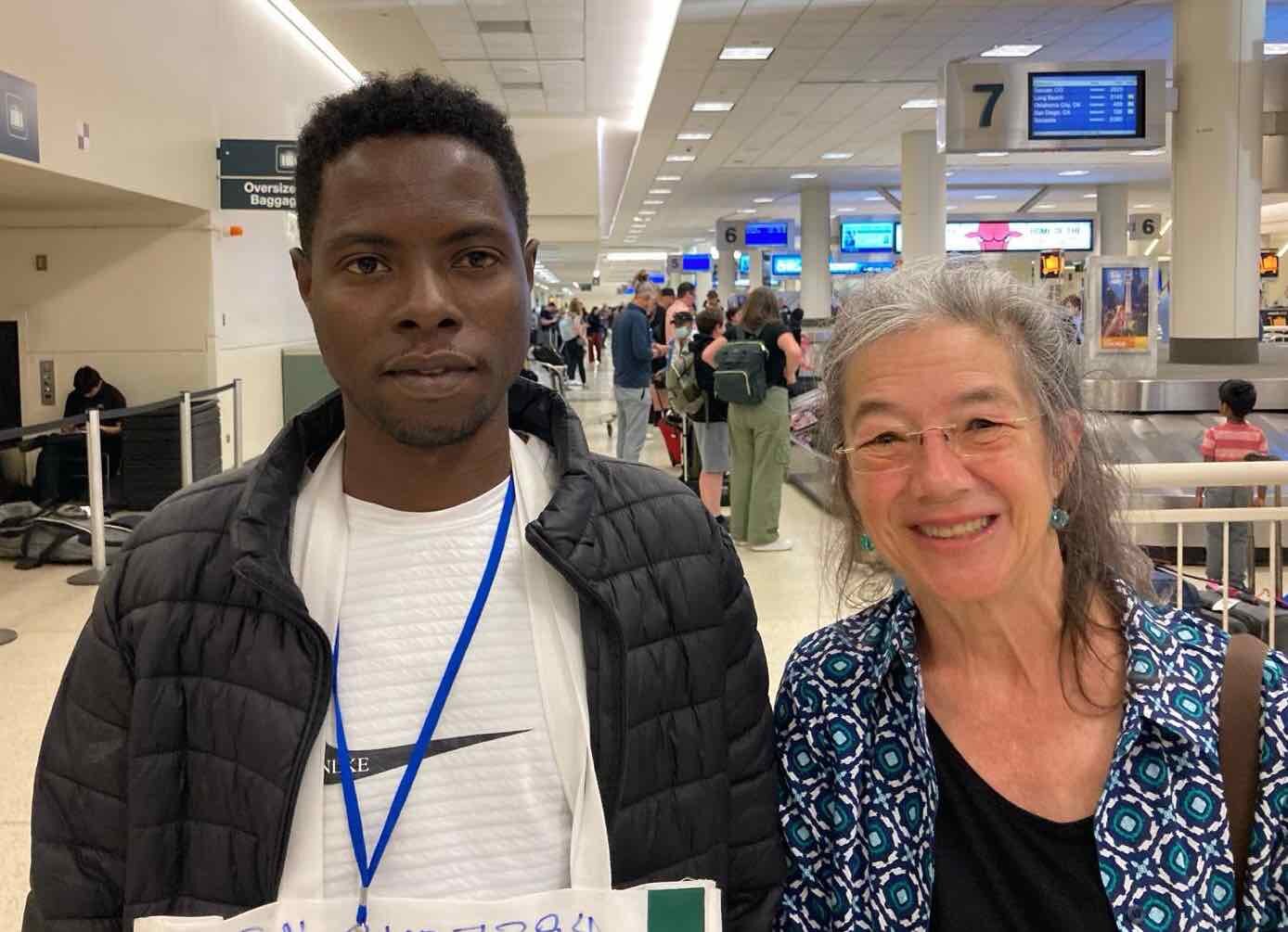 Newcomer Mohammed arriving at the airport to a welcome from Ruth, a member of the Cassopolis, Mich., private sponsor group that worked with Zaman during the 90-day resettlement period 