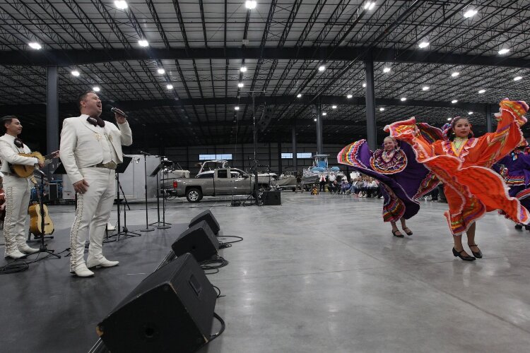 Gustavo Hernandez, of Mariachi Garibaldi de Jaime Cuéllar from Los Angeles, California, sings the song “Guadalajara” as members of Ballet Folklórico Sol Azteca dance while performing at the Holland Symphony Orchestra’s “Mariachi & the Movies” communi