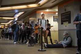 18-year-old Max Tendero (seated) in November of 2016, waiting to vote in the Union basement at the University of Michigan.