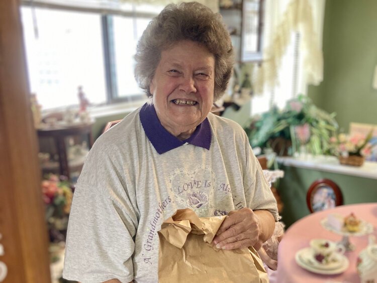 A delighted client receives her Meals on Wheels Western Michigan delivery.