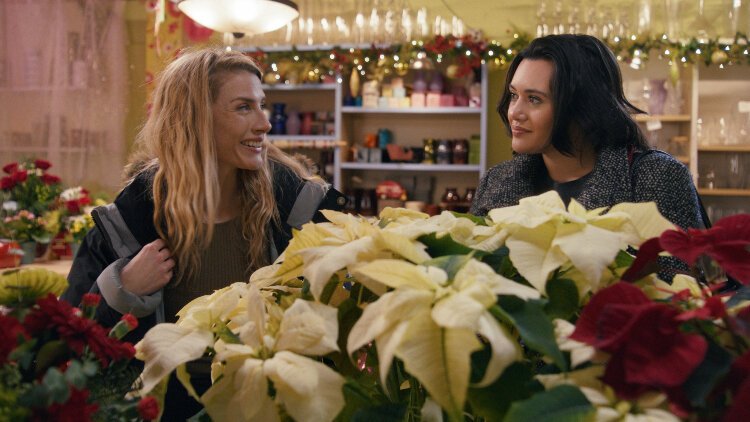 Lindsay Hicks as Jane and Rivkah Reyes as Sue in a flower shop.