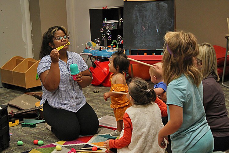 Music therapist Kara Lewis entertains children.