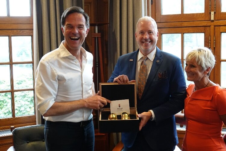 Holland Mayor Nathan Bocks and his wife, Elizabeth Bocks, present a gift to Prime Minister Mark Rutte during an unofficial visit on Oct. 9.