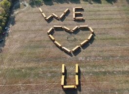 As Mike Hoekstra took a dream balloon ride with his wife and family, he was surprised with a heartfelt message from his colleagues who used 28 school buses to spell out “We love you.”  