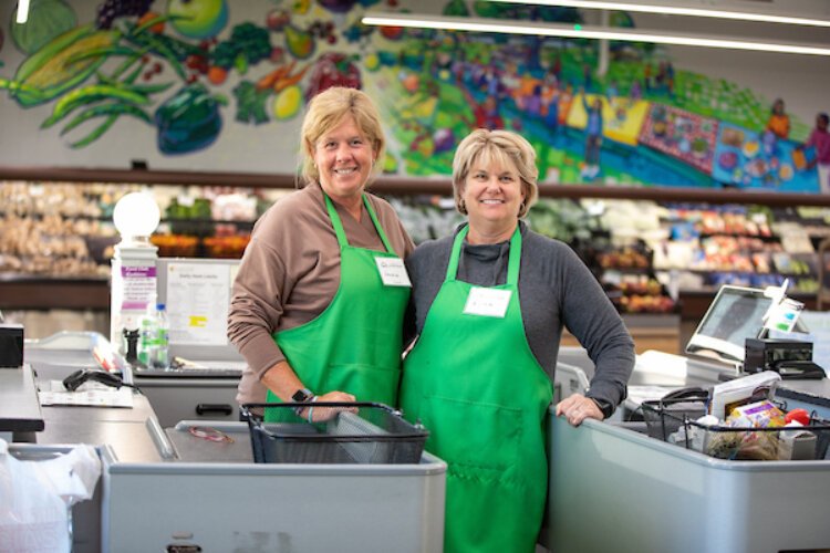 Volunteers are cashiers at Community Action House Food Club.