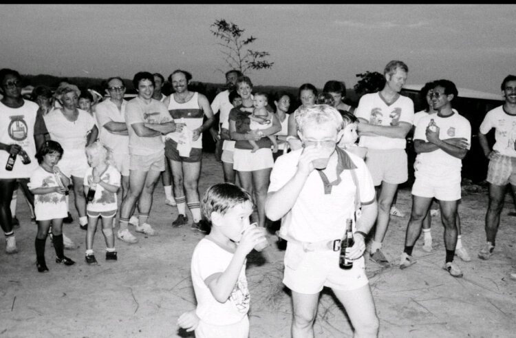 Charles Elwood as a small child (front, center) with his father, and Elwood's sister (in backpack) at a hash run race through the jungles of Borneo in 1983.