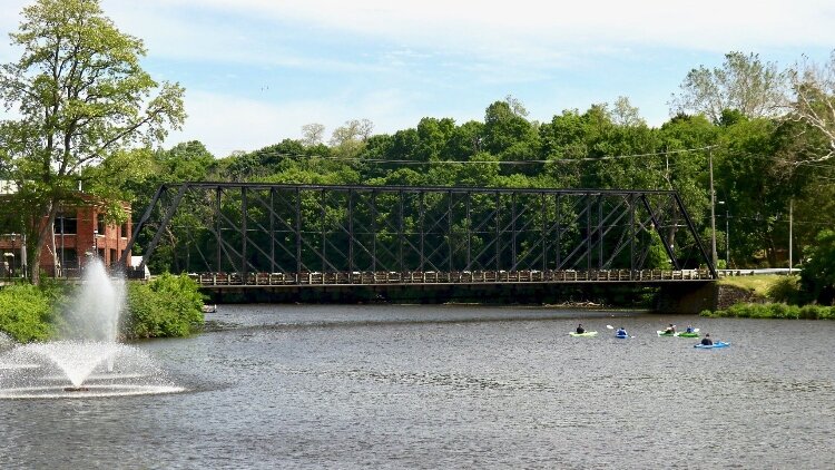 Kayak pass under the Old Iron Bridge in downtown Allegan. (City of Allegan)