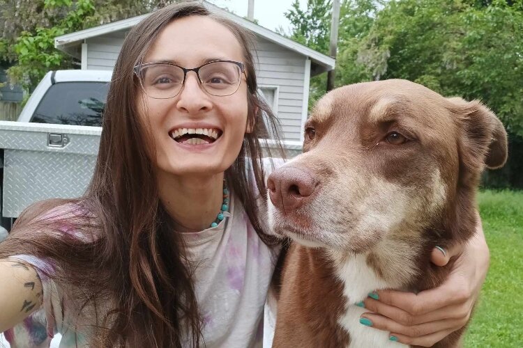 Poet Emiliah Tanya Jo Odinsdottir with her dog, FenRir.