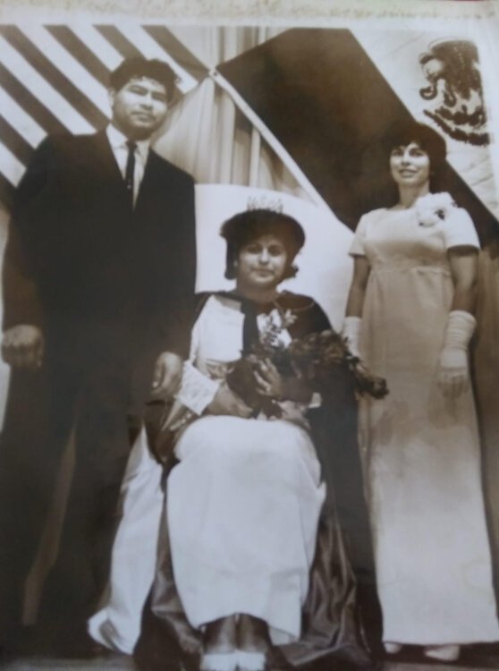 Lu and Tito Reyes pose with the first Fiesta queen in 1964.