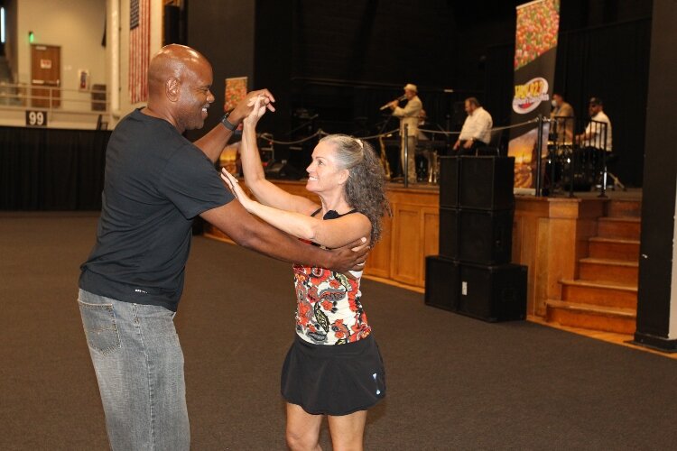 Christopher Smith and Therese Miller, of Minneapolis, Minnesota, dance to a cha-cha song being performed by Tumbao Bravo, an Afro-Cuban jazz band of Ann Arbor, Michigan, while attending the International Festival of Holland at the Holland Civic Cente