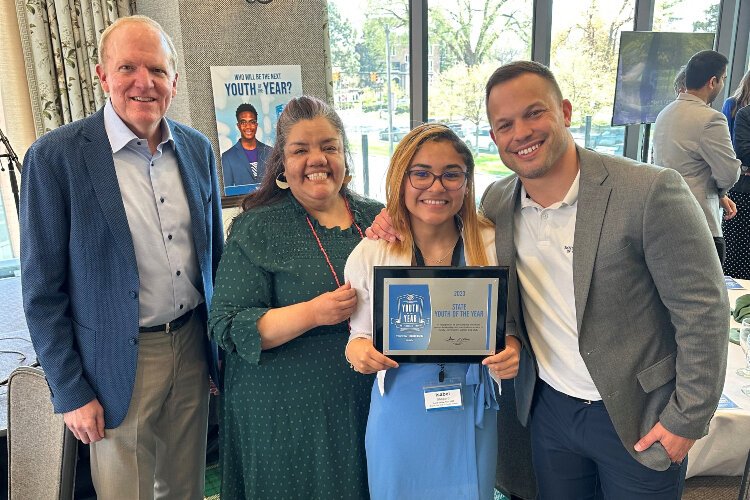 Boys and Girls Club staff celebrate with Isabel Shepard (center) after she was named Michigan Youth of the Year.