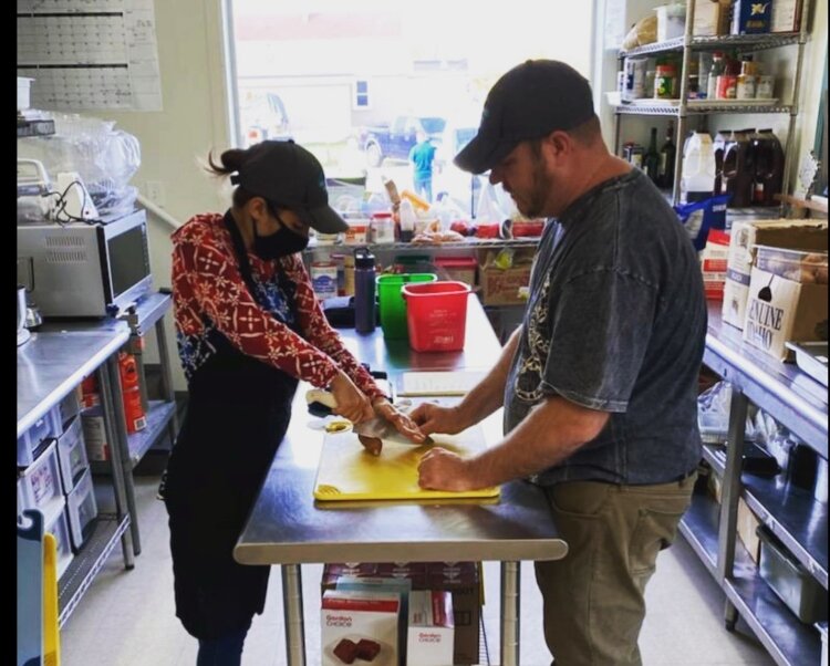 Workers prep food for the Eat More Do Good kitchen.