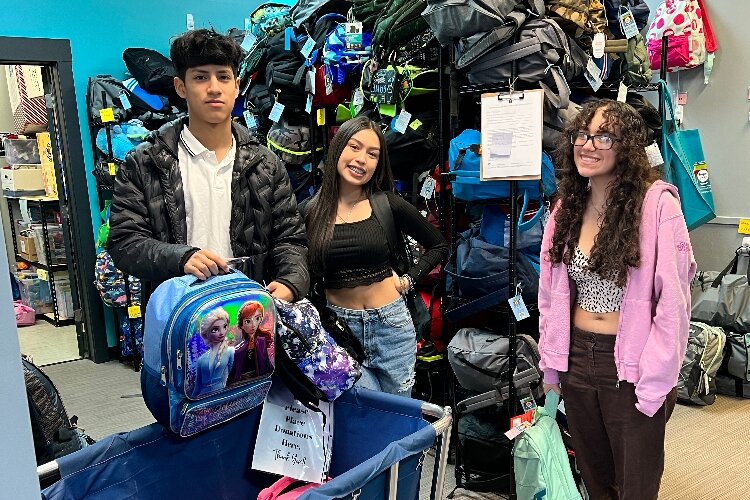 Karinna Martinez (center), a junior at Holland High School, is busy volunteering for the LAUP Adelante program, the Holland Youth Advisory Council, and Women of Color Give.