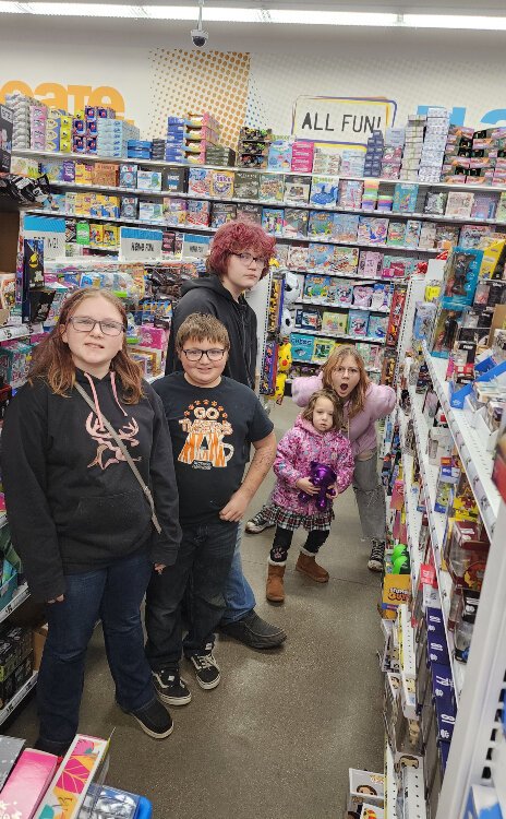 LeighAnne Henderson and her children shopped for gifts for the  Community Action of Allegan Holiday Giving program.