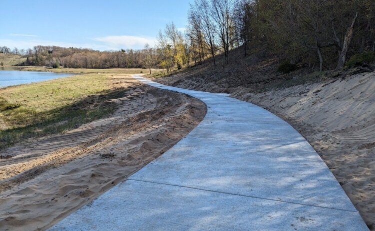 New features at Ottawa Sands County Park include ADA-compliant parking, modern restroom facilities, a paved 1.6-mile “Lake Loop” trail with accessible benches, and a universally accessible kayak launch along the Grand River. 