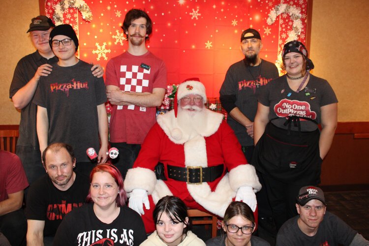 Staff of the Allegan Pizza Hut pose with Santa.