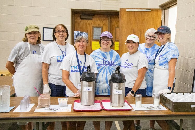 Volunteers help provide hot meals and showers to Refresh guests.