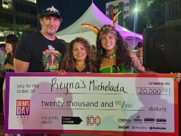 Reyna Masko, center, poses with her husband, left, and daughter.