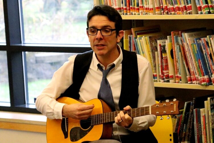 Michigan Library Association 2024 Public Librarian of the Year Rob Carpenter often brings his guitar to storytimes.