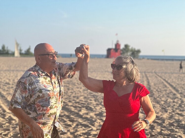 Juan and Julie Mascorro demonstrate their salsa dance moves on the beack at Holland State Park.