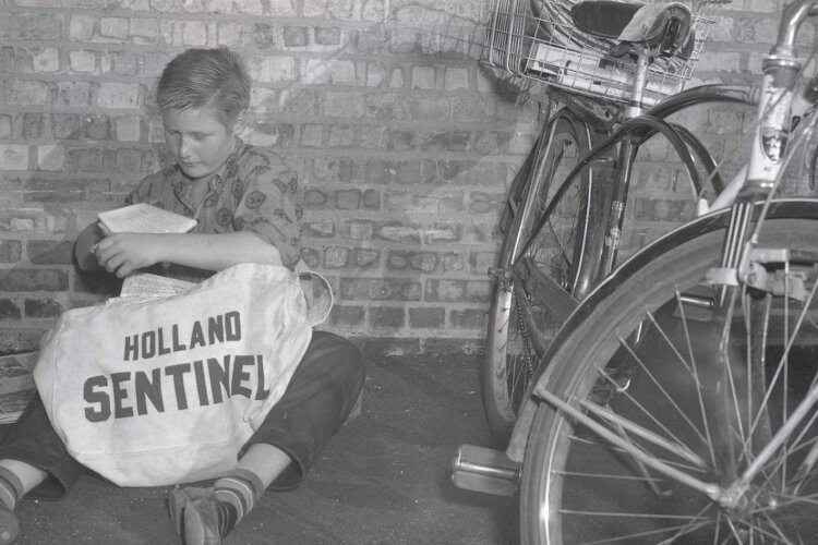 Mike Myrick, 12, getting ready to deliver the Holland Sentinel in October 1960.