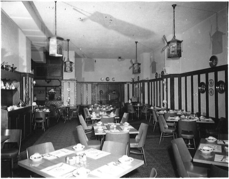 The dining area at The Warm Friend Hotel is shown with stained glass pendants. One of the pendants remains at the Warm Friend today.