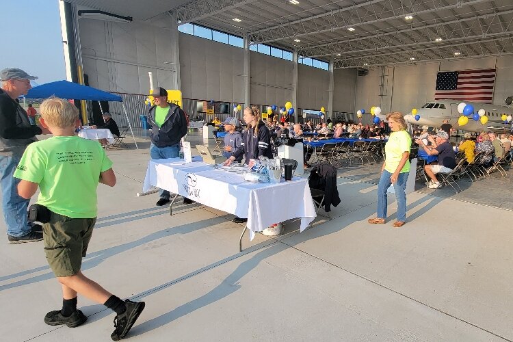 Attendees to the National Aviation Day at the West Michigan Regional Airport on Aug. 19 enjoy breakfast. (Boileau & Co)